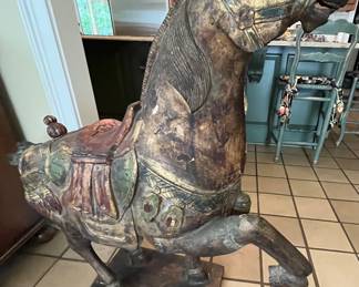 Hand carved horse statue.  It stands about 4' tall.