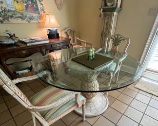 This pineapple-base table has four arm chairs that go with it.  Thick, beveled glass top.
