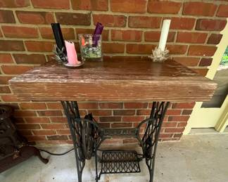 Old sewing machine base, with a cutting block mounted to top.  A good sanding and staining, and this piece could go inside.  