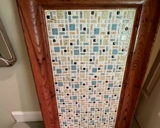 This is a great tray, or it can be hung on the wall -- as it is set up to be now.  It has a hook and wire on the back.  The tiny vintage tile is so pretty.  Great colors also.