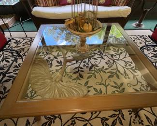 Glass top table with metal flower