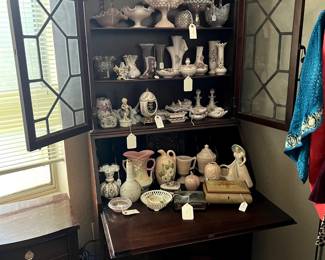 Antique Desk - doors open, has drawers on the bottom- it is housing antique collectibles... 