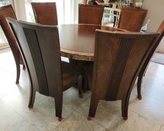 round dining table with faux marble trim on top, with 8 chairs