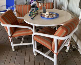 PVC Outdoor table (48” dia) and 4 chairs with thick colorful like new cushions 