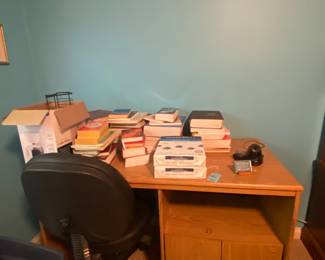 Desk loaded with office supplies.