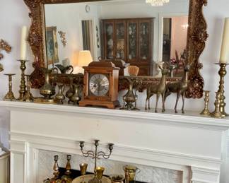 large ornate vintage mirror, brass candlesticks and ewers, Hamilton mantle clock, pair of brass reindeer, electric fireplace