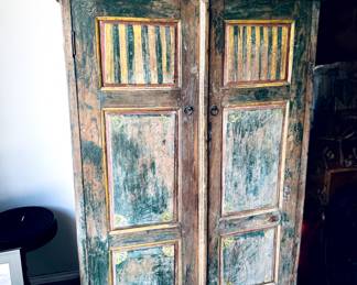 Really cool painted/aged armoire with shelves.