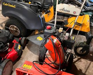 Lawn equipment including zero turn Cub Cadet and Ariens snow blower.