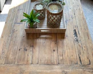 large wooden coffee table, decorative tray, candle holders, plants
