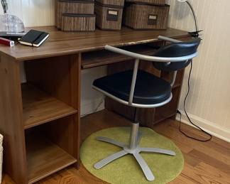 wood desk, organizer baskets, chair rug, swivel office chair, desk lamps.