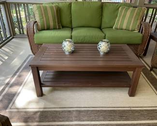 swivel rocking outdoor glider, wood coffee table, throw pillows