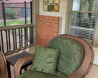 rattan armchair, green leaf cushions