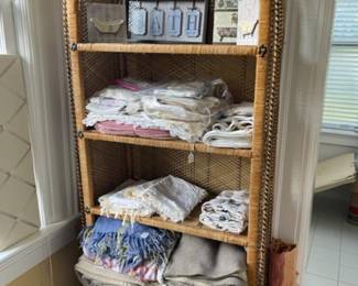 Rattan shelf loaded with linens