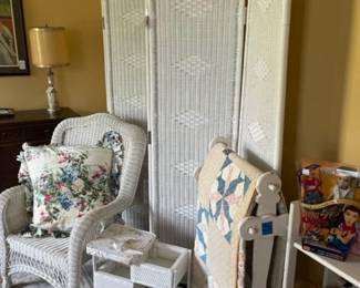 Wicker screen, one of the three wicker chairs, antique quilt