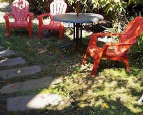 Plastic adirondack chairs, table and umbrella
