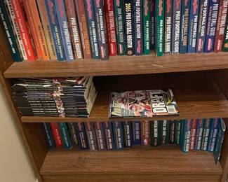 Assorted Sports Books And Bookcase