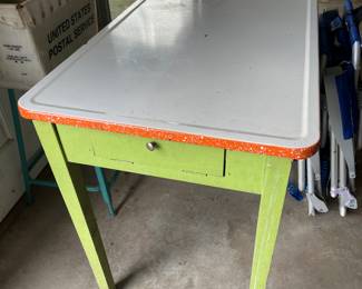 Antique enamel top table with ironing board in draw