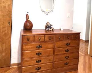 Solid maple dresser with deep drawers. Vintage doll on stand - musical. White oval mirror.  