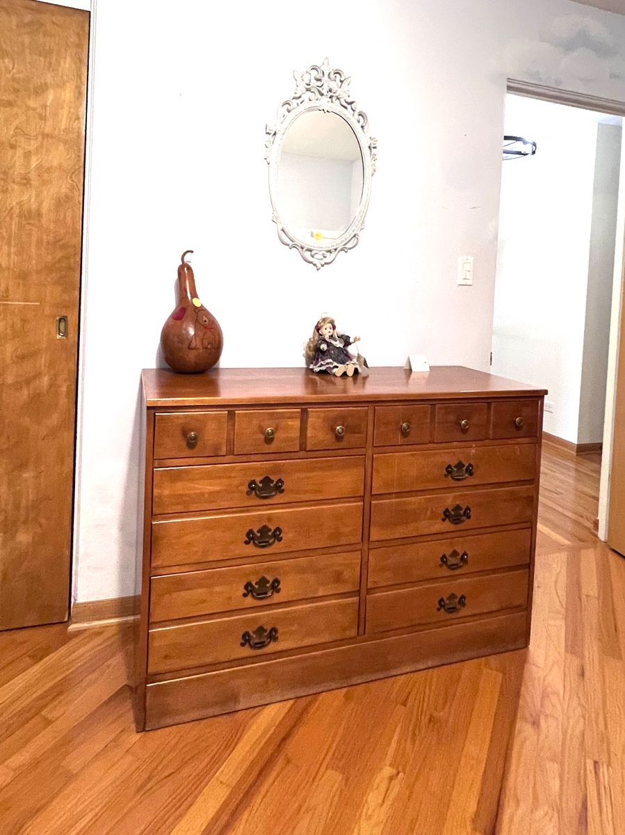 Solid maple dresser with deep drawers. Vintage doll on stand - musical. White oval mirror.  