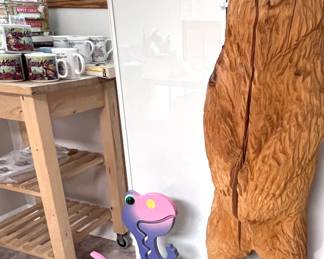 Chainsaw carved bear. Does have a split. Girl's dinosaur bank in excellent condition.  