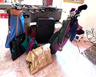 2 sets of golf clubs, suitcase, duffel bags, computer bags. 