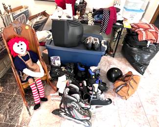 Men's and women's rollerblades and roller skates. Bowling balls, children's rocking horse, cross country ski shoes. Skis not shown. Box fans.