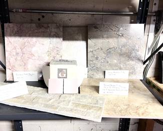 Pink/salmon marble floor tile, gray/black marble floor tile, brown/beige ceramic floor tile, beige/white stone backsplash. 