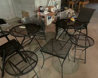 Wrought iron patio set. Two tables, four chairs and three end tables.