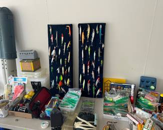 Garage - Multitude of fishing equipment including lures! Many other fishing items are available at this quality sale.