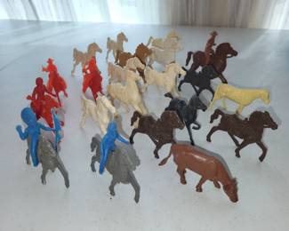 Vintage toy plastic horses, some with riders