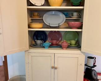 Pale yellow kitchen cupboard 
Fiesta Dishes 