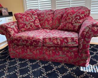 Deep red loveseat with attached cushions, some wear, very comfortable 68"W