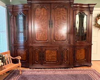 Wall-size 4-piece entertainment cabinet with pull-out cd organizers below and glass lighted display shelves on each side 7ft. 5in. H x 9ft W x 26in D