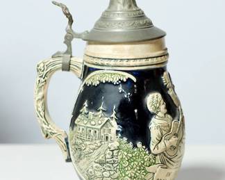 Handle left view of vintage ceramic German beer stein with a pewter lid (#4), inscription reads "In Vino Veritas, Aber Auch Im Bier Etwas"