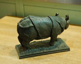 Back detail of bronze Rhinoceros sculpture with Minerva Fine Arts, London, England label on the bottom