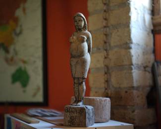 Antique wood carving, figure of a pregnant woman on a pedestal with the title "Because of You"