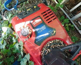 Detail of red Toro Power Clear lawn mower