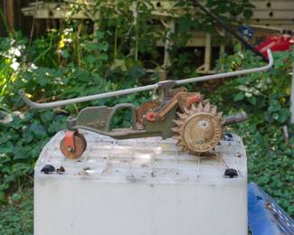 Detail of cast-Iron tractor-form, walking lawn sprinkler