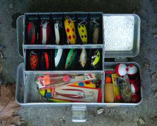 Metal tackle box full of fishing lures and fishing gear