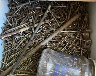 Drawer full of nails in metal workshop cabinet