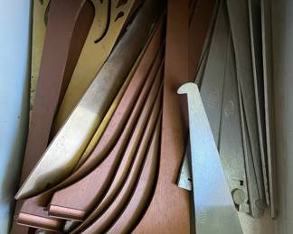 Drawer full of decorative hardware in metal workshop cabinet