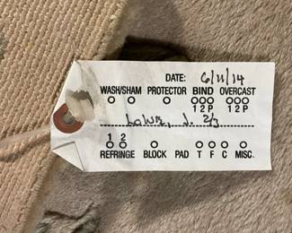 Tag detail of floral design gray, pink, and green rug