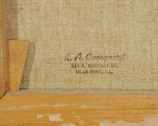 Back detail of oil painting of boats and a colorful village shoreline.  Previous owner or dealer stamp reads K.A. Overgard, 619 E. Madison St, Villa Park, ILL