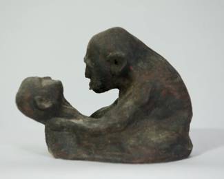 Back view of Mid Century studio pottery sculpture of a man holding a child, signed Becker.