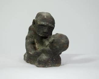 Side view of Mid Century studio pottery sculpture of a man holding a child, signed Becker.