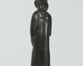 Back view of African wood sculpture of a bearded man holding a staff