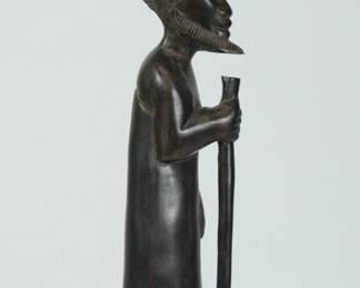 Other side view of African wood sculpture of a bearded man holding a staff