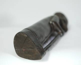 Bottom of African wood sculpture of a bearded man holding a staff