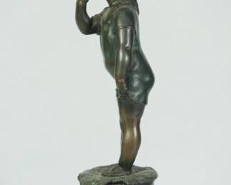 Side view of bronze sculpture of a standing child