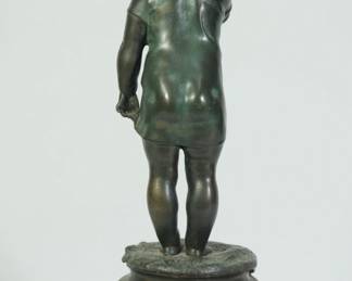 Back view of bronze sculpture of a standing child